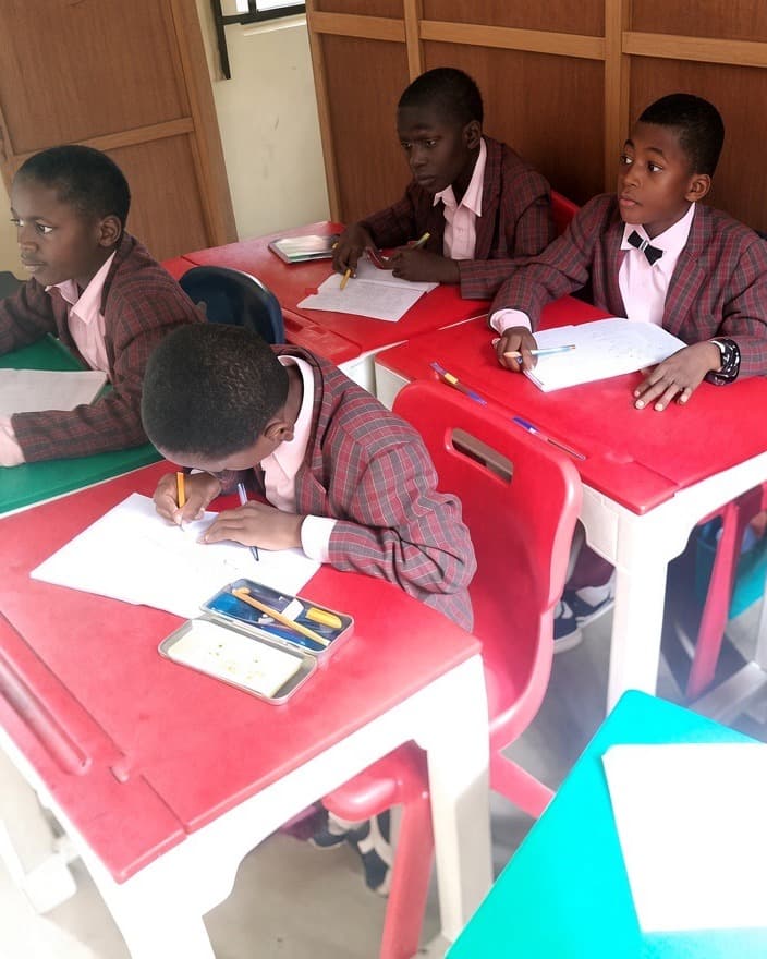 Pupils of Excellent Yisheng Digital Schools writing at their desks in class